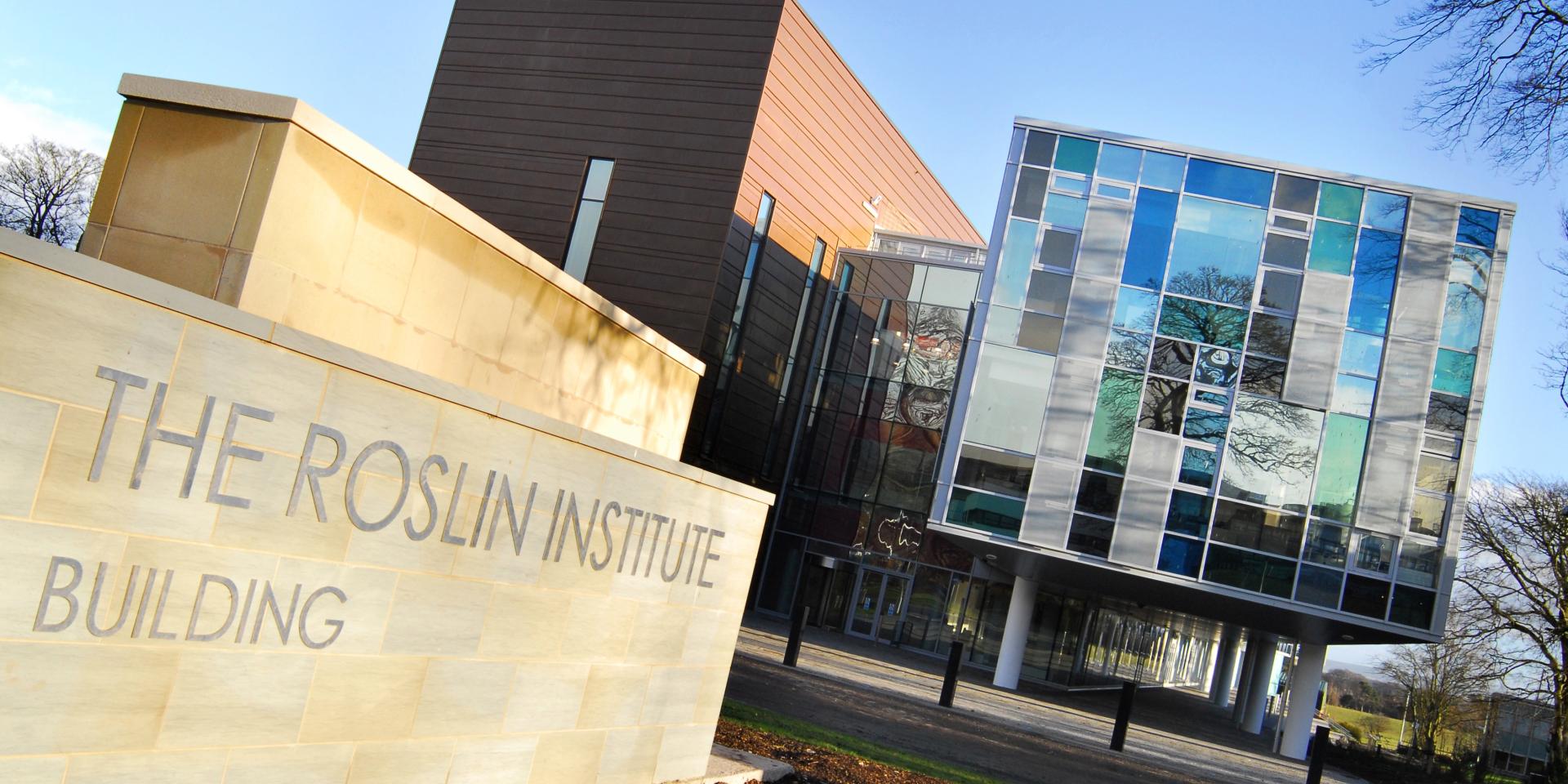 A diagonal view of the front entrance of the Roslin Institute at the University of Edinburgh, made up of modern concrete and glass buildings. The image is displayed in landscape orientation with 2:1 ratio styling.