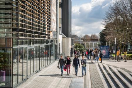 A group of students walk past the Murray Library on the King's Buildings campus on a sunny day. The image is displayed in landscape orientation with 450x300 pixel dimensions.